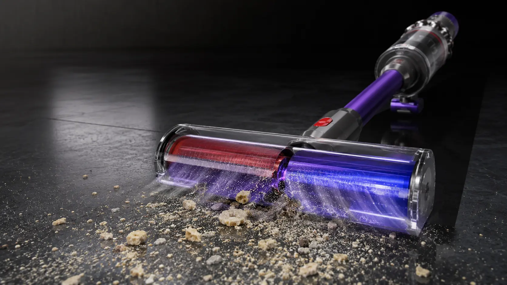 Dyson cleaner head lifting debris from a dark floor